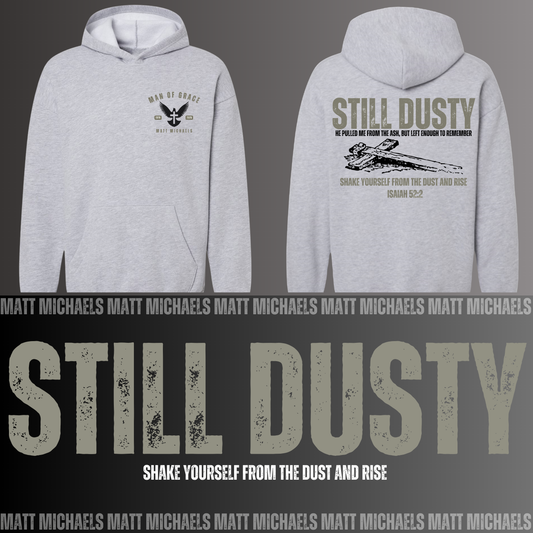 Gray hoodie with 'Still Dusty' text and design on a dark background