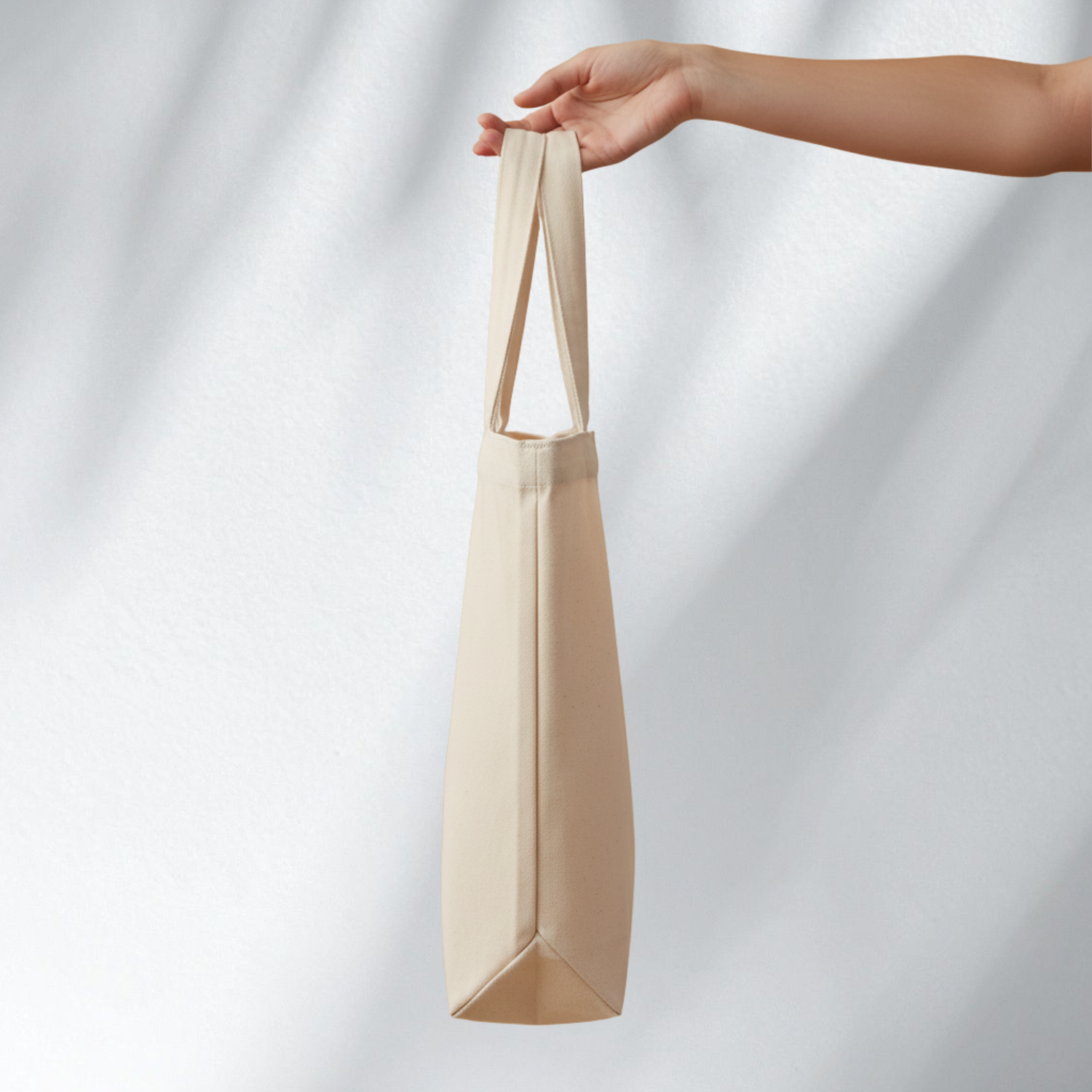 Natural canvas tote bag held from the side, Matt Michaels accessories collection