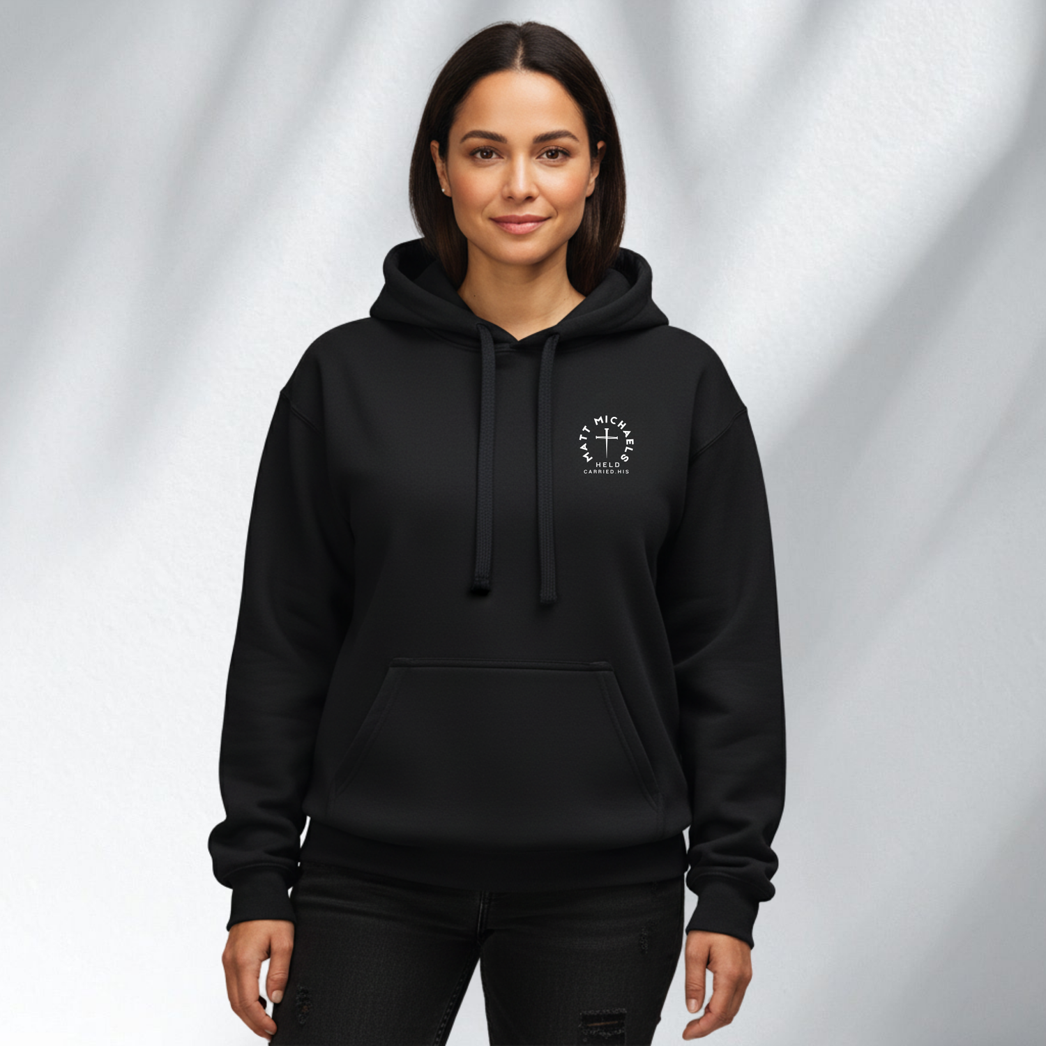 Woman wearing a black Matt Michaels hoodie with logo, womens streetwear collection