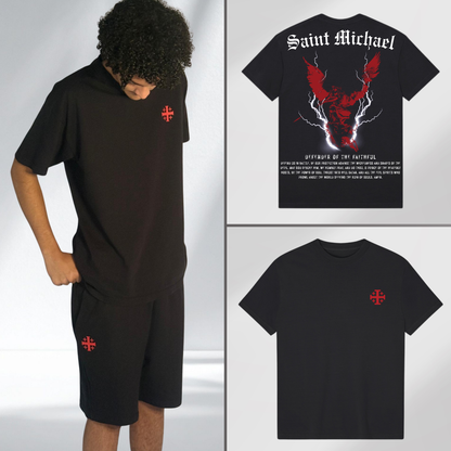 Model wearing black St Michaels tee with red Jerusalem cross emblem on chest and matching shorts. Faith-rooted streetwear, back of black tee with Saint Michael prayer.