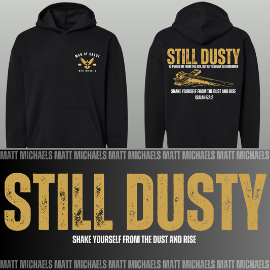 Black hoodie with 'Still Dusty' text and design on a gray background