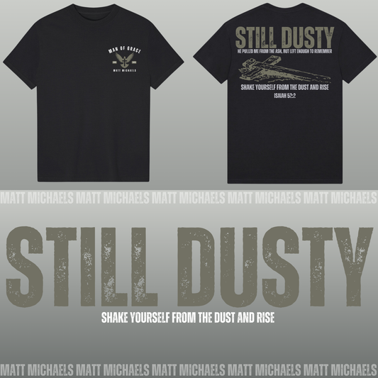 Black t-shirt with 'Still Dusty' design and text on a gray background