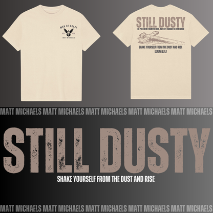 Beige t-shirt with 'Still Dusty' design on a dark background