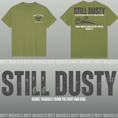 Green t-shirt with 'Still Dusty' text and design on a gray background