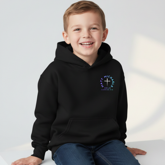 Child wearing a black hoodie with matt michaels logo on a studio background